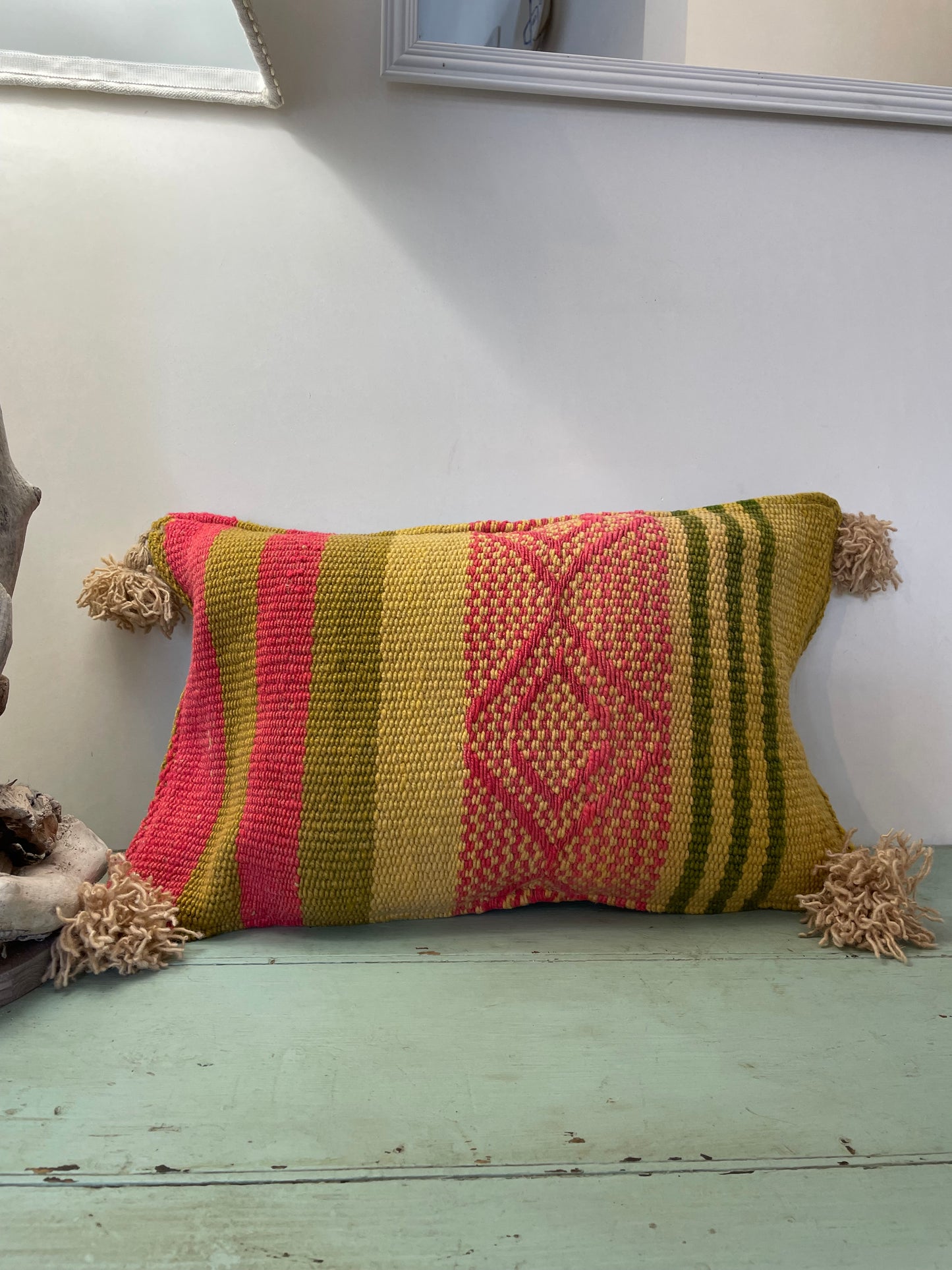 Wool cushion with pom-poms